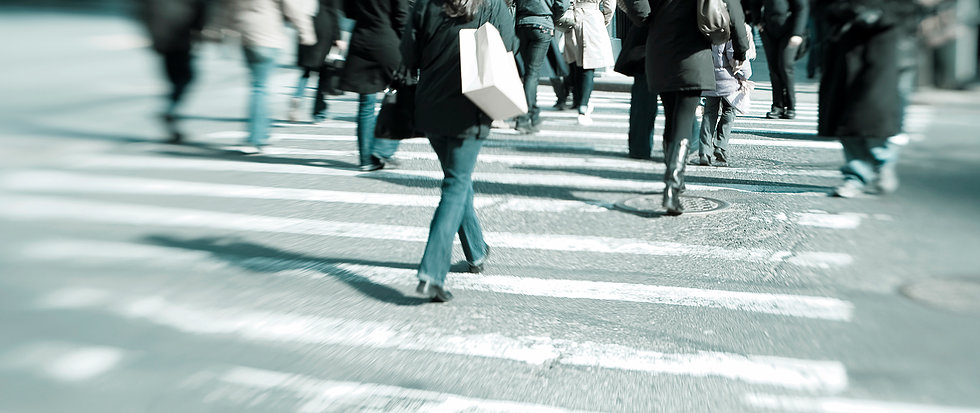 Shot of urban commuters crossing street through a Lensbaby lens for motin effect